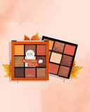 Nicka K Nine Color Eyeshadow Palette in Autumn Spice with warm, earthy shades arranged in a compact palette for versatile eye looks.